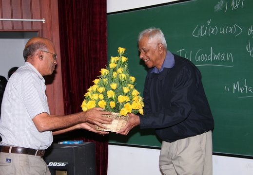 (L-R) Prof.R.Baskaran handing over a bouquet of flowers to Prof.N.Mukunda 