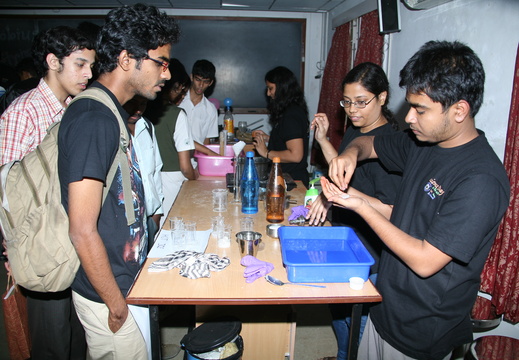 Volunteer demonstrating an experiment to the participants during National Science Day celebration on 27 February 2011